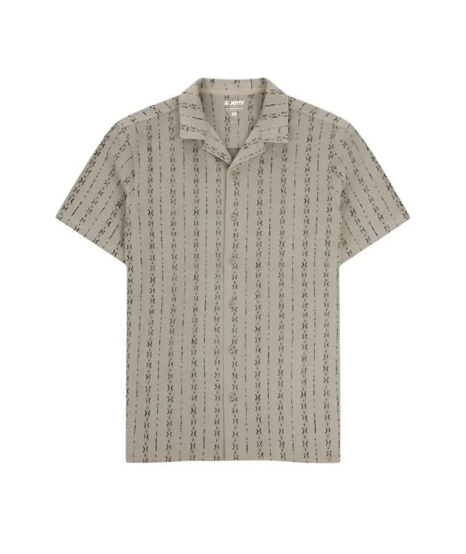 Tan short sleeve knit button down shirt with camp collar and subtle jacquard pattern, displayed flat on white background.
