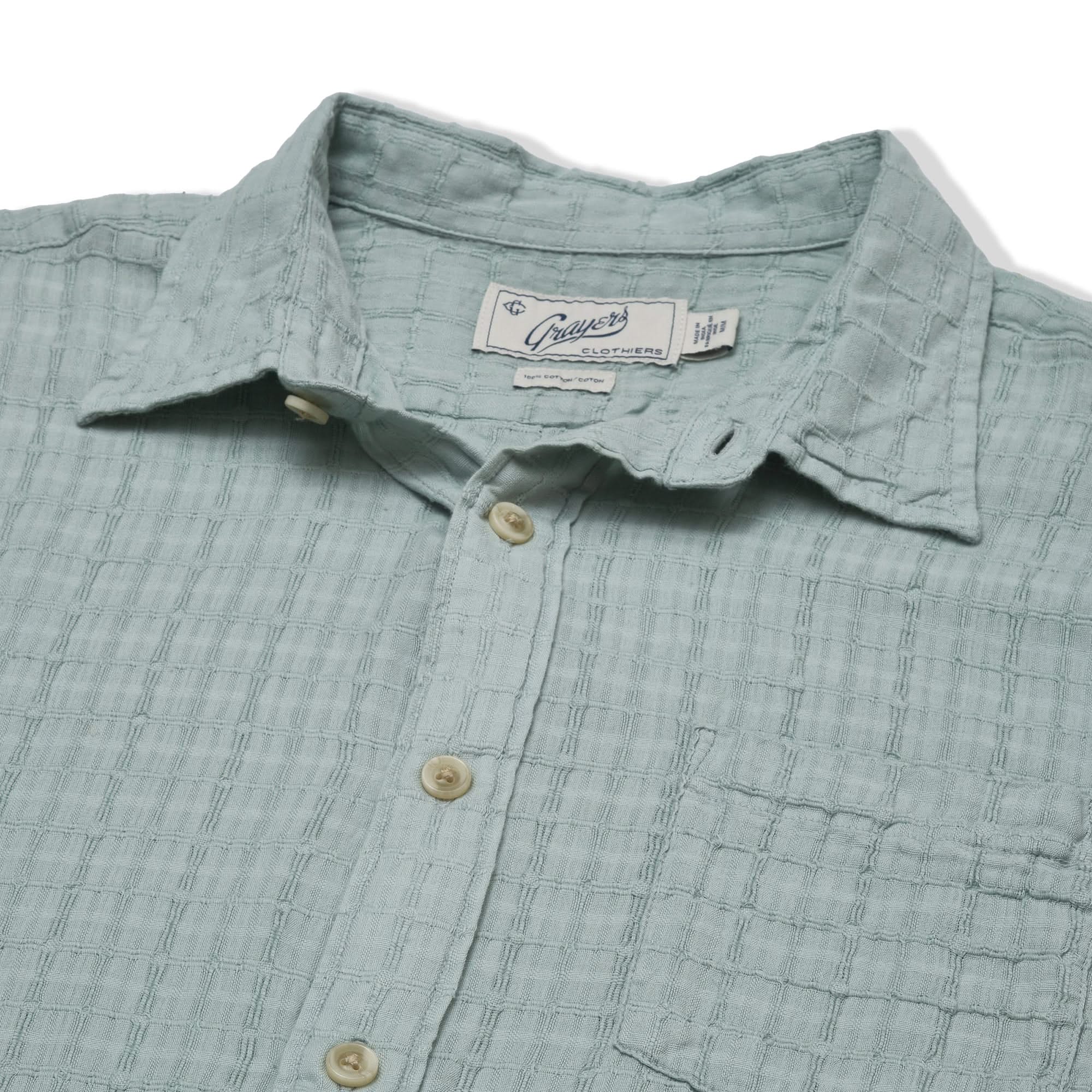 Close-up of the Bamboo Dobby Shirt’s textured fabric, natural buttons, and collar detail, highlighting the soft 100% cotton dobby weave.