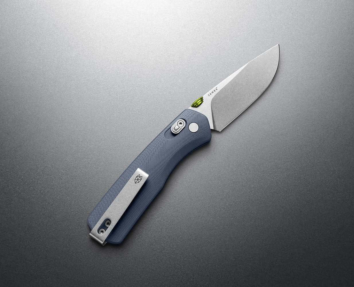 Full view of Tidal Blue Carter folding knife with stainless steel blade and deep-carry clip, resting on dark metal surface – men's EDC gear from The Simple Man.