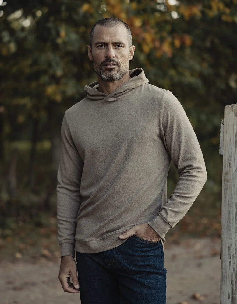 Outdoor lifestyle photo of Puremeso Essential Hoodie in taupe – durable men’s hoodie worn in cool weather, styled with jeans, sold at The Simple Man.