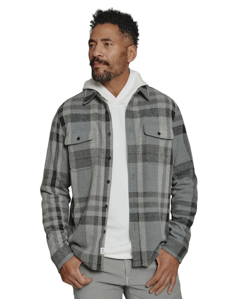 Front view of model wearing Generation Plaid Shirt in grey with layered hoodie for fall or winter style