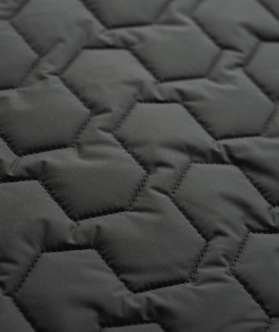 Close-up detail of hexagon quilted black fabric on the Inlet Puffer Jacket – water-resistant men’s insulated jacket from The Simple Man.