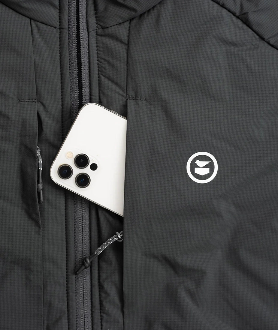 Zippered chest pocket on the Inlet Puffer Jacket holding smartphone – black men’s puffer jacket with secure storage and Oystex insulation