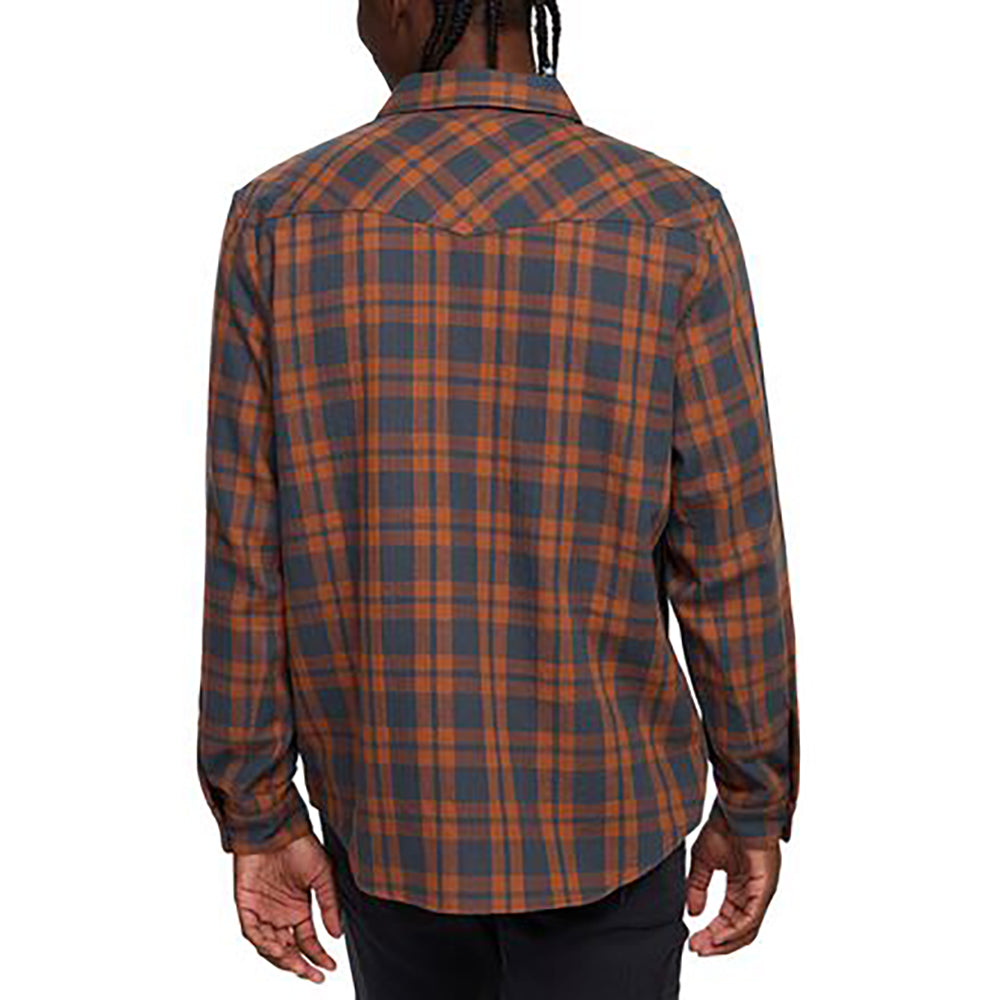 Rear view of man wearing Howler Brothers La Grange Flannel Shirt in rust and navy plaid with western yoke details