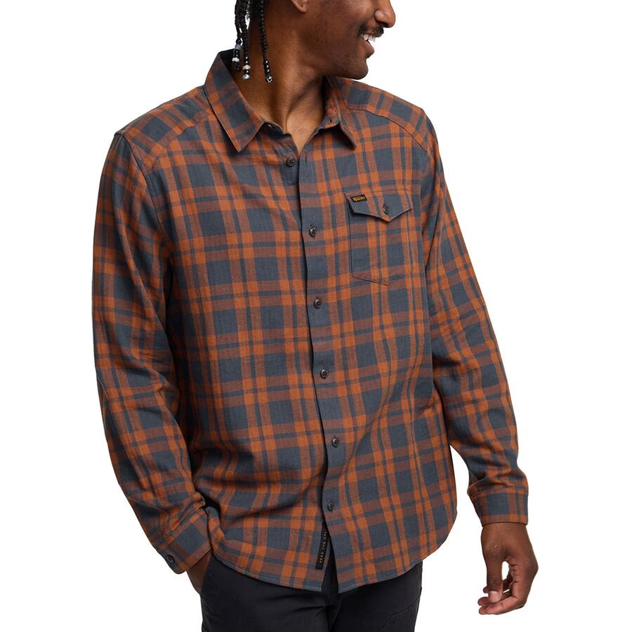 FRONT  view of man wearing Howler Brothers La Grange Flannel Shirt in rust and navy plaid with western yoke details