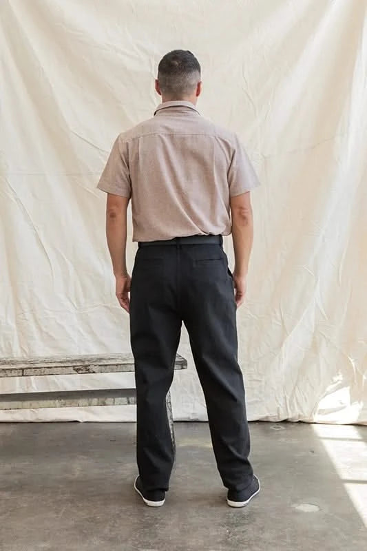 Model Wearing Bridge & Burn Malcom short sleeve chambray shirt in rust chambray color, rear  view