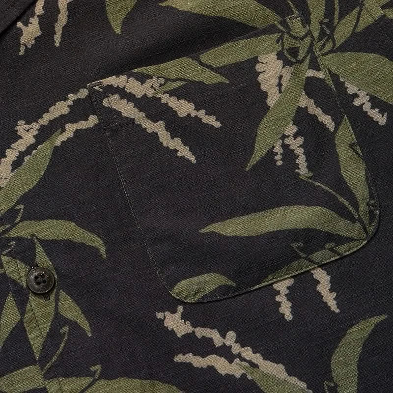 Howler Brother's Momoloha Shirt, lily negatives pattern, black with green, flat lay close up fabric detail view