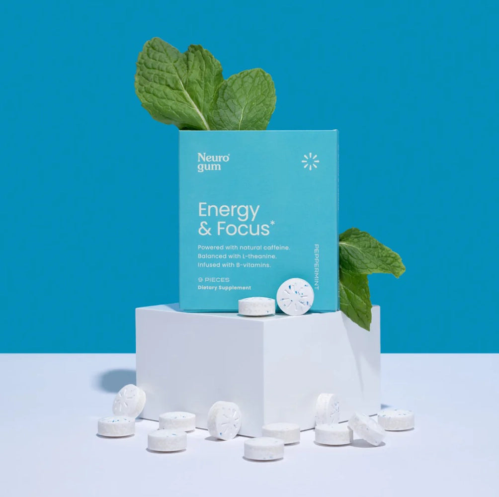 Neuro Gum Energy & Focus peppermint flavor—9-piece pack with fresh mint leaves and caffeine mints on a blue background