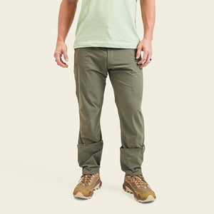 Model Wearing Howler Brothers Shoalwater tech pants in oregano color, front view