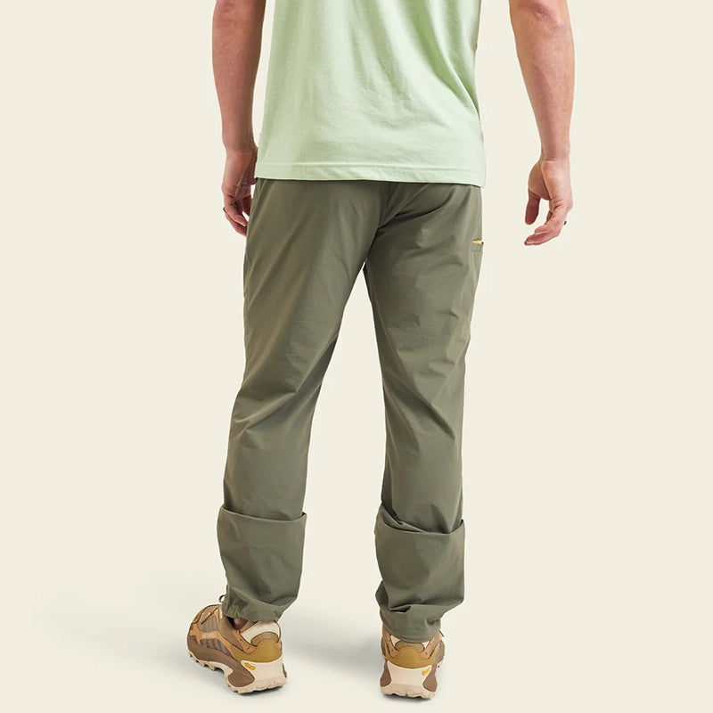 Model Wearing Howler Brothers Shoalwater tech pants in oregano color, rear view