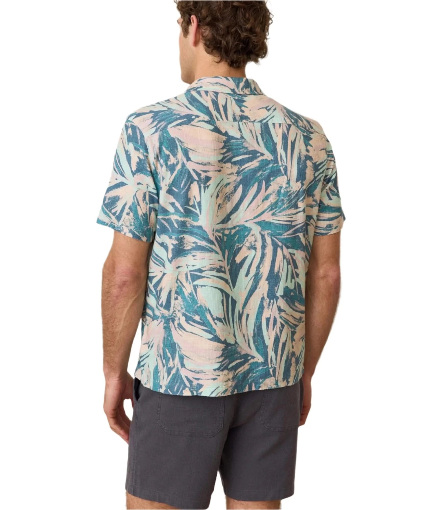 Model wearing Marine layer stretch selvage shirt in abstract palms print, casual shirt, rear  view