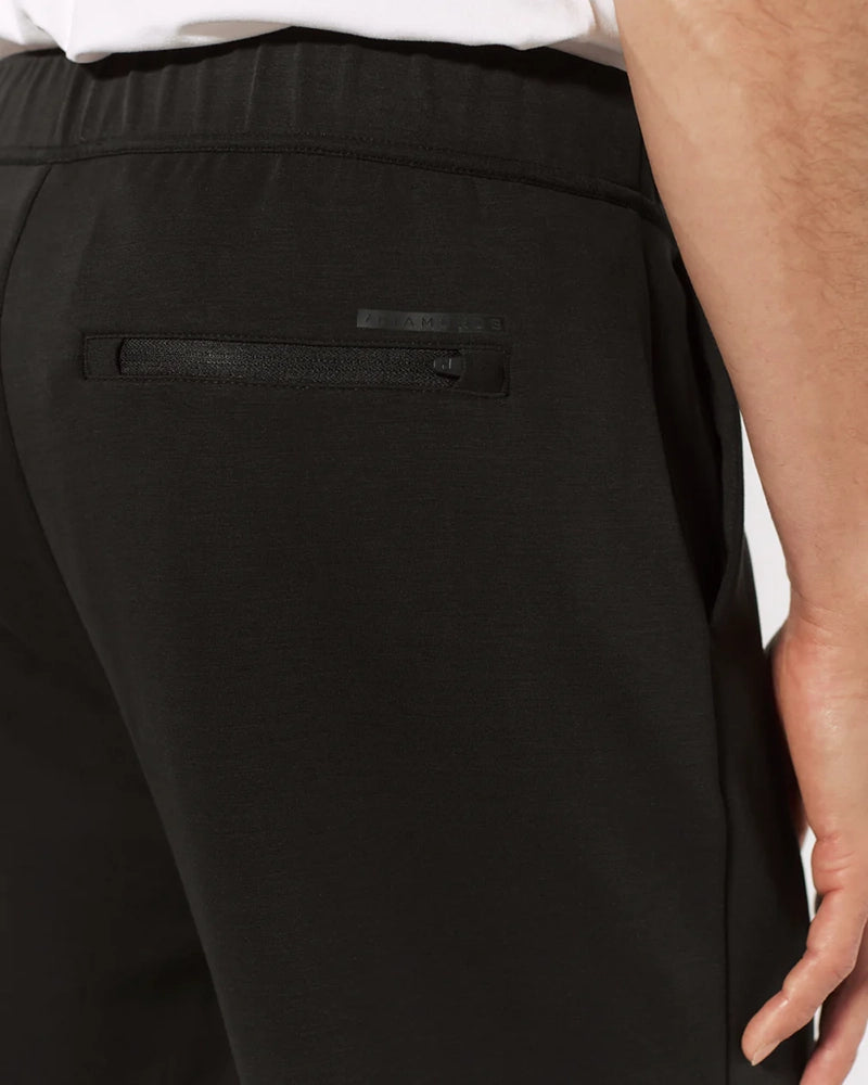 Detail shot of black REV™ Jogger back pocket with hidden zipper and tonal logo – sleek, functional design