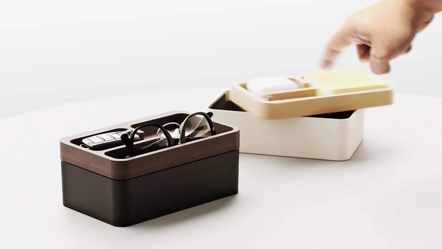 Revov Rotating Tray box in black, and white  shown filled  with everyday carry items.