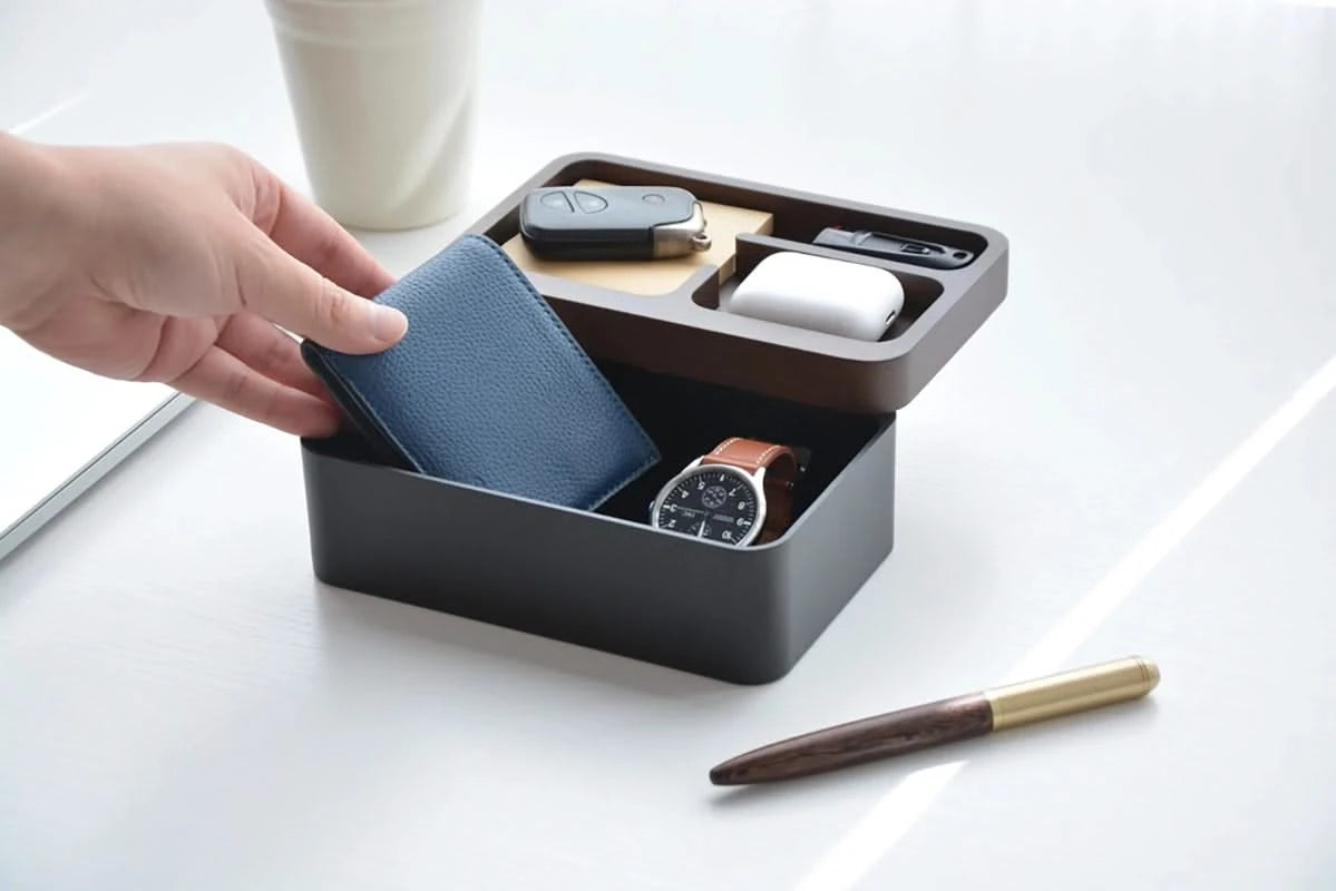 Revov Rotating Tray box in black, shown filled  with everyday carry items. lid rotated open