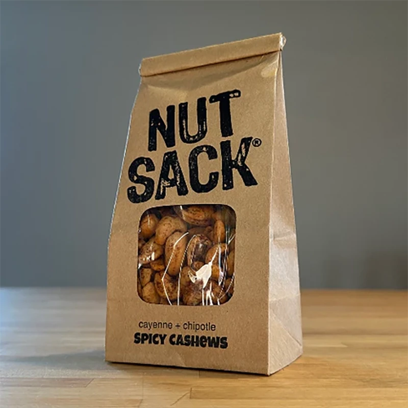 Nut Sack Spicy Cashes mix, 6oz bag, front of bag on a table