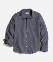 Flat lay of men’s stretch selvage long sleeve shirt in India Ink with pearl buttons