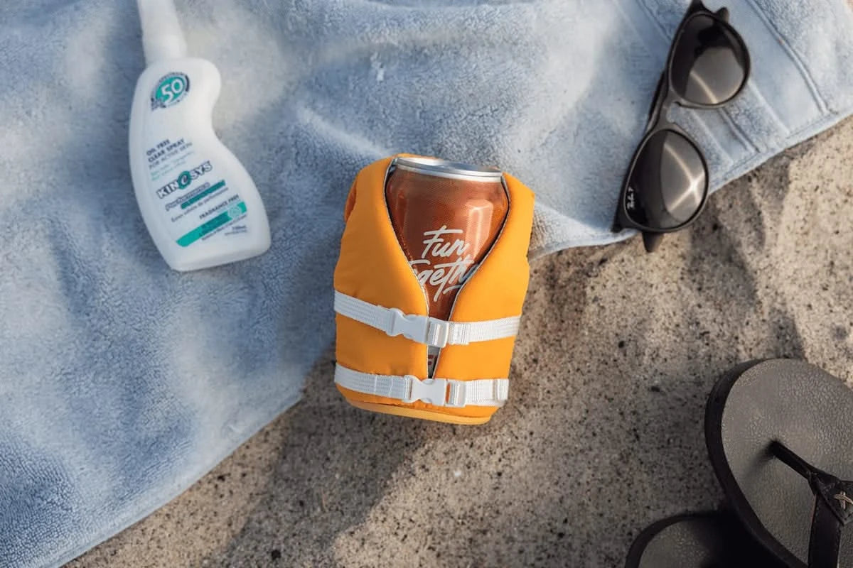 Buoy-style floating can cooler keeping drink cold at the beach