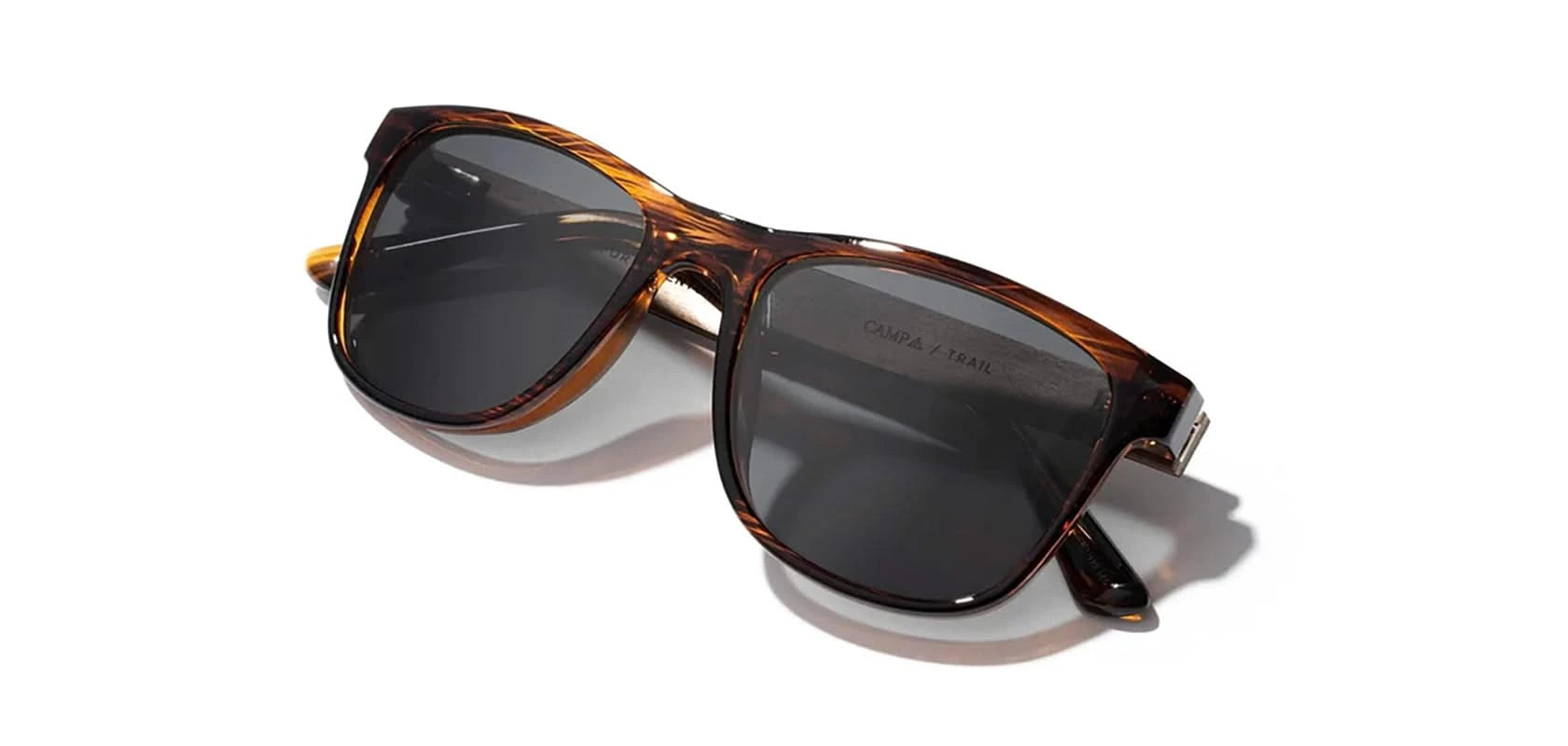 Camp trail Sunglasses with Tortoise/Walnut Frames and Grey Polarized lenses, front angled folded temple view