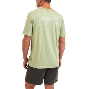Model Wearing Howler Brothers tropic of howler pocket t-shirt in Julep Color, rear view