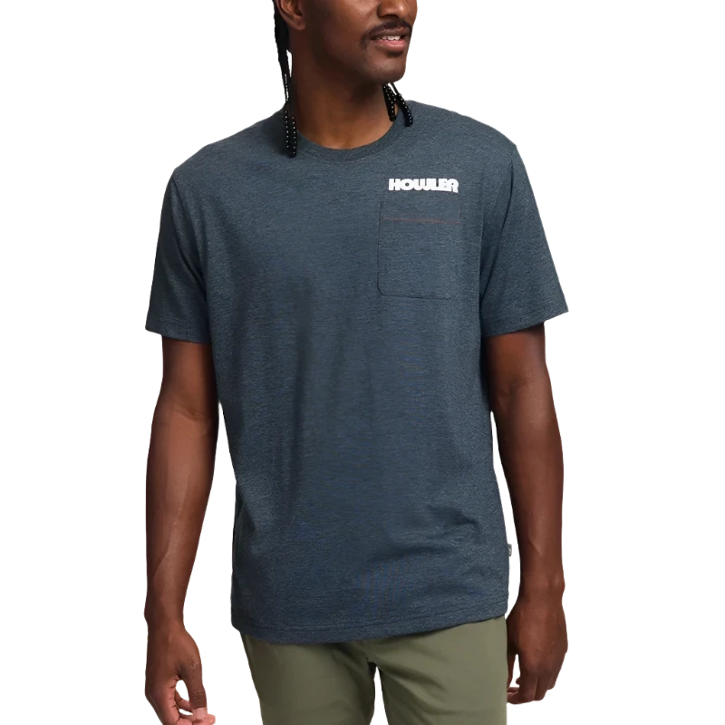 Model wearing Howler Brothers Trucha T-shirt in charcoal, design printed on the back.