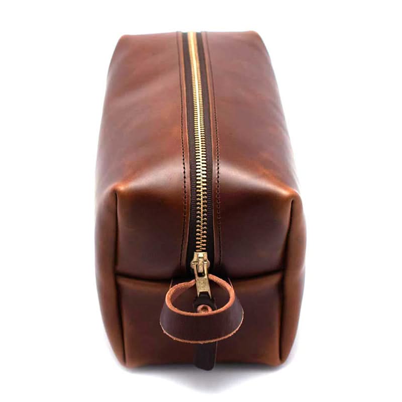 Top view of waxed leather travel bag for men with durable YKK brass zipper – high-quality dopp kit