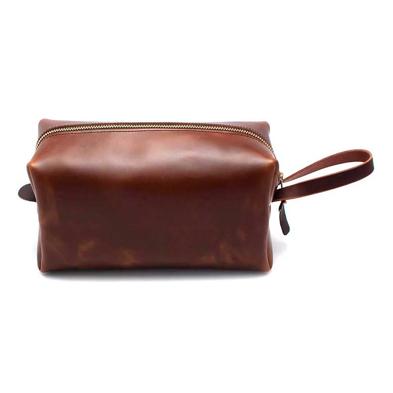 Side profile of brown leather men’s dopp kit with handle loop – rugged travel toiletry bag