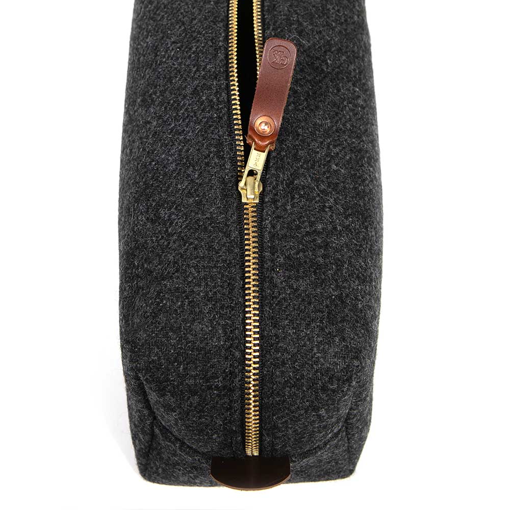 Close-up view of the Charcoal Wool Travel Kit zipper and leather pull tab