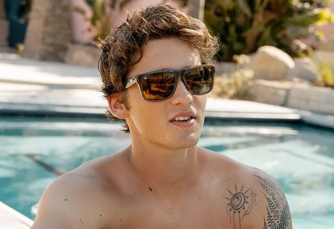 Model wearing Knockaround Torrey Pines Sunglasses in riverbed colorway, angled front view