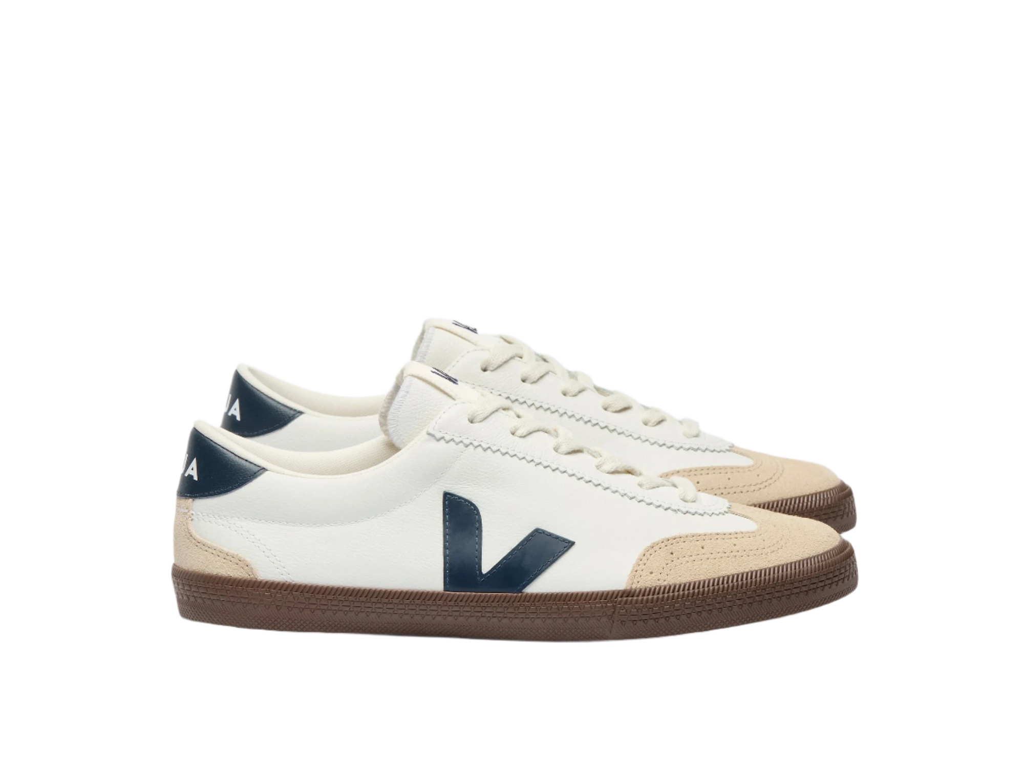 Side view of VEJA Volley men's sneakers in white organic leather with navy logo, tan suede accents, and brown rubber sole – available at The Simple Man."