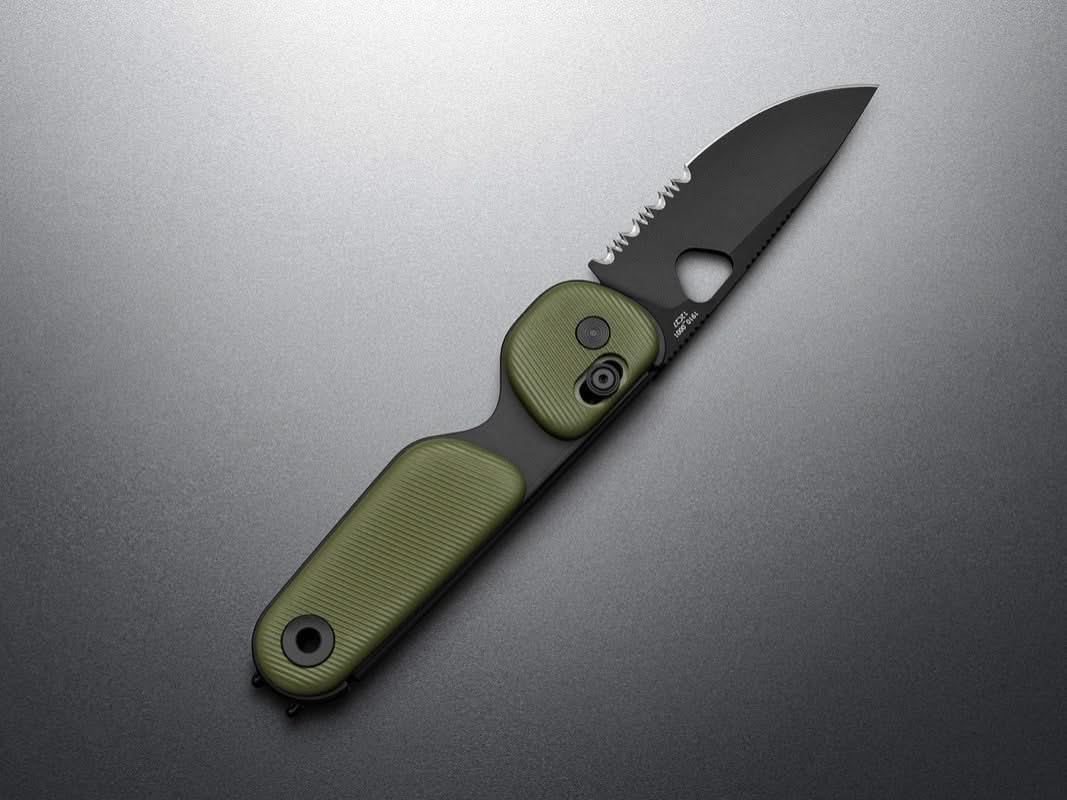 Redstone compact folding knife with serrated drop point blade in OD Green with black blade color, featuring slide-lock and bent-wire pocket clip – available at The Simple Man. Extended blade shown