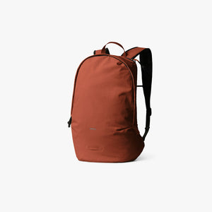 Bellroy Lite Daypack in Clay, a lightweight rust-orange packable backpack, front three-quarter view - The Simple Man