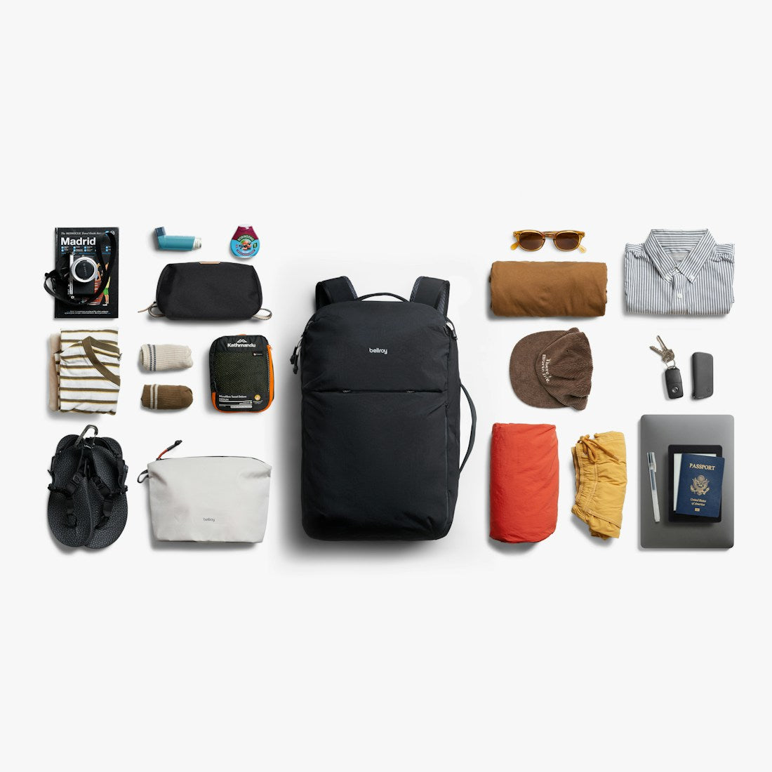 Bellroy Lite Travel Pack 38L carry-on backpack in Black, flat lay of travel items beside the pack - The Simple Man