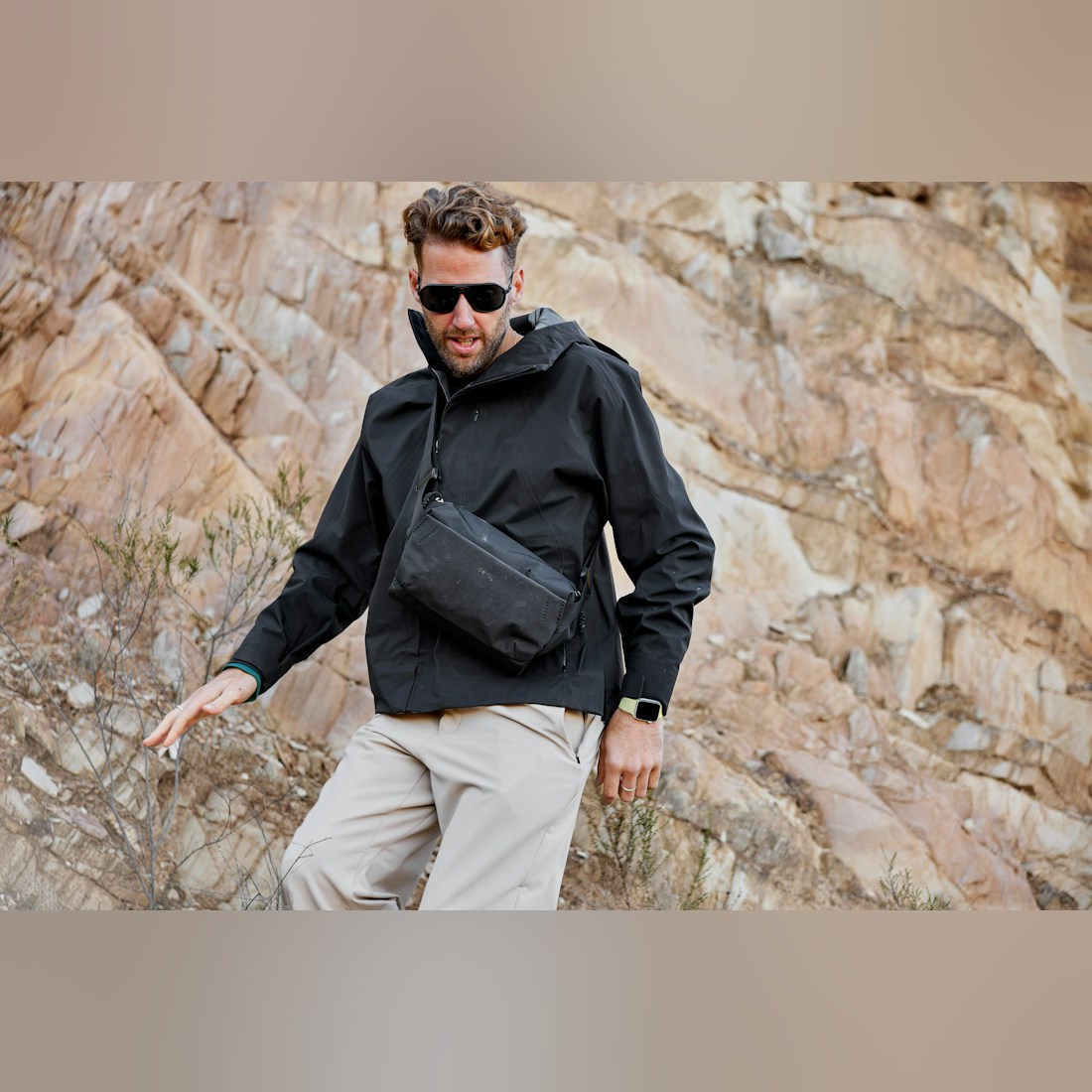 Bellroy Venture Sling 6L in Black, worn across the chest by a man on a rocky hillside - The Simple Man
