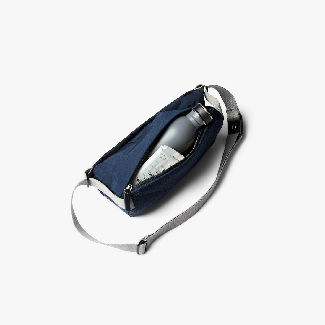 Bellroy Sling Mini sling bag in Navy, worn across the body - The Simple Man