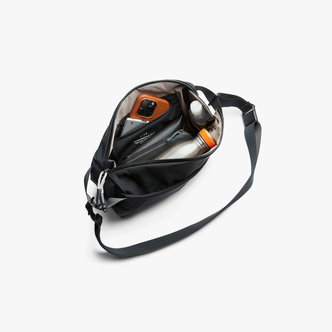 Bellroy Lite Sling in Black, worn across the body with the strap visible - The Simple Man