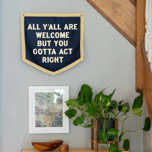 All Y'all Are Welcome camp flag hanging on wall, lifestyle photo, The Simple Man