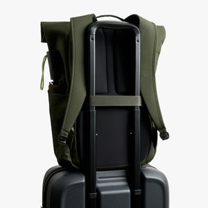 Bellroy Classic Rolltop commuter backpack in Olive, back view riding on a suitcase handle with luggage pass-through - The Simple Man
