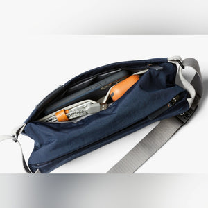 Bellroy Sling Mini sling bag in Navy, open with contents and leather tab - The Simple Man