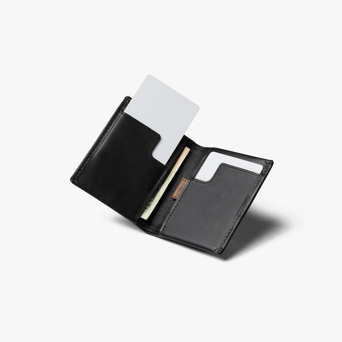 Bellroy Slim Sleeve wallet in Black, open at an angle with a card pulled up - The Simple Man