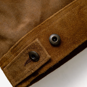 Close-up of the metal shank button side tab on the brown suede jacket - The Simple Man