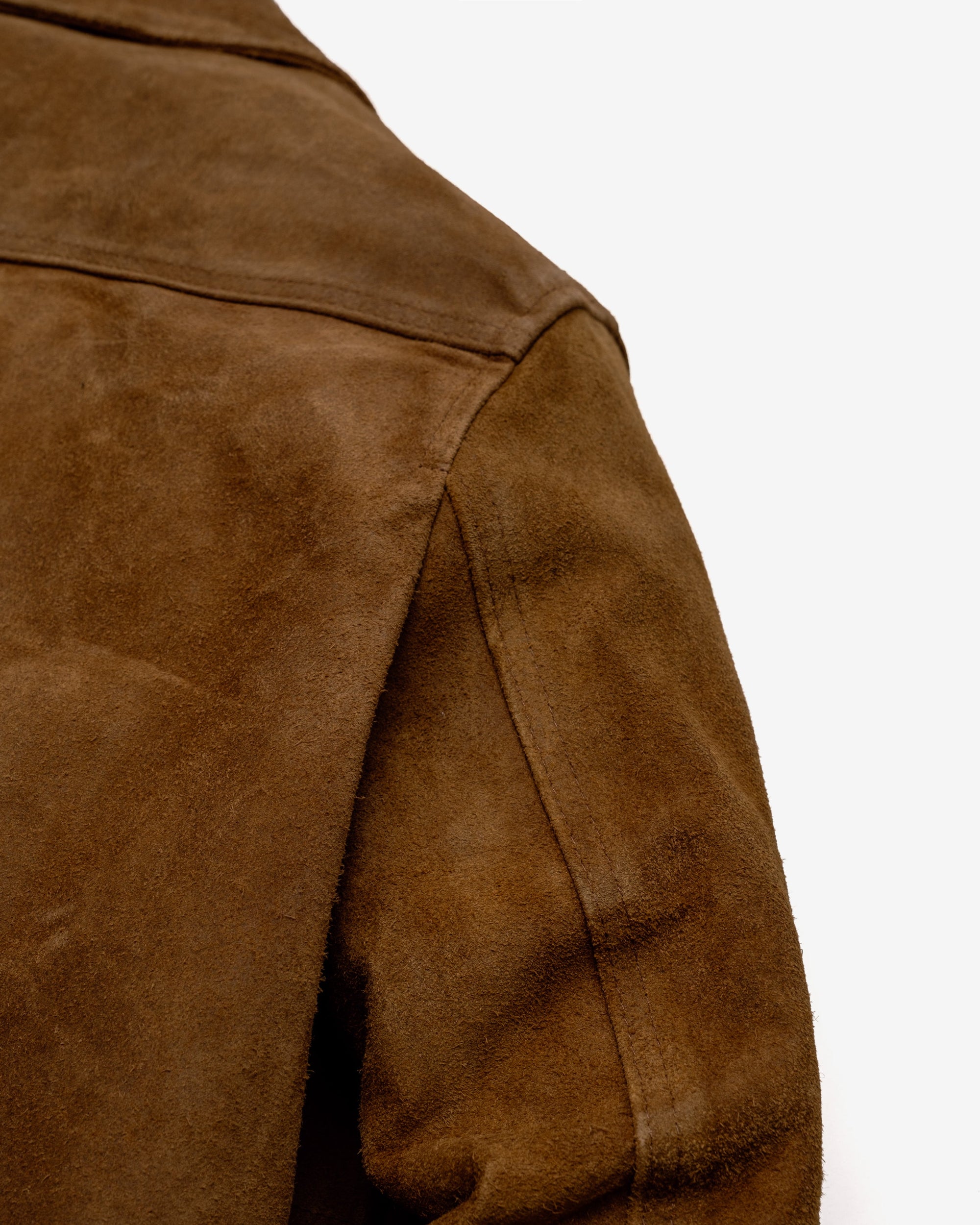 Close-up of the shoulder and sleeve seam on the brown rough-out suede jacket - The Simple Man