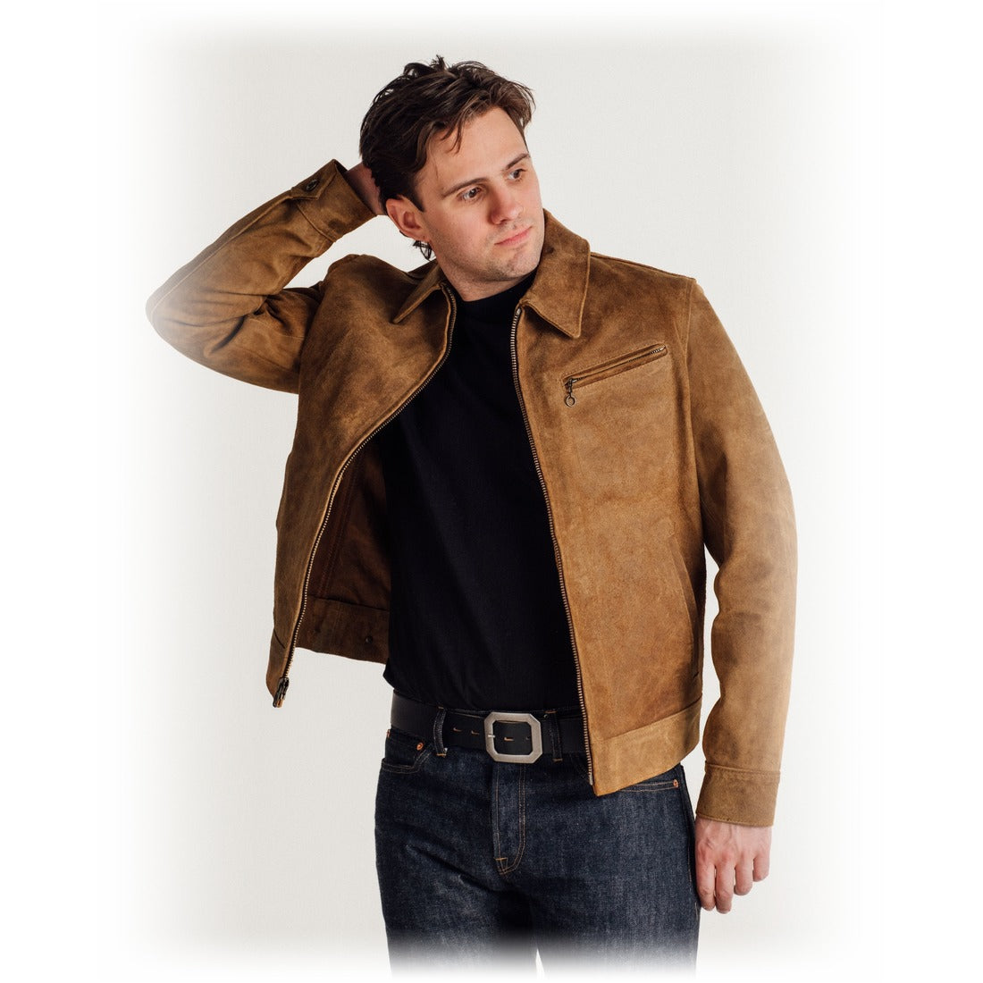 Man wearing the brown rough-out suede jacket open over a black tee and dark jeans - The Simple Man