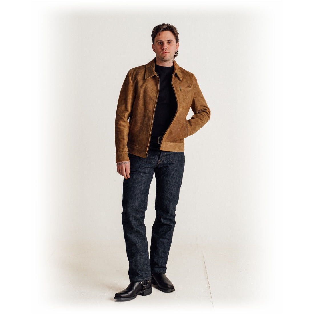 Full length view of a man wearing the brown rough-out suede jacket with dark jeans and boots - The Simple Man