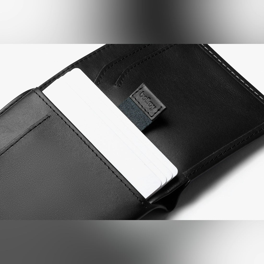 Bellroy Note Sleeve RFID leather wallet in Black, close-up of the pull tab with a card - The Simple Man