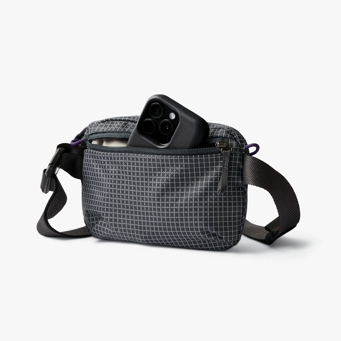 Bellroy Lite Belt Bag in Arcade Grey, front view with a phone in the side pocket - The Simple Man