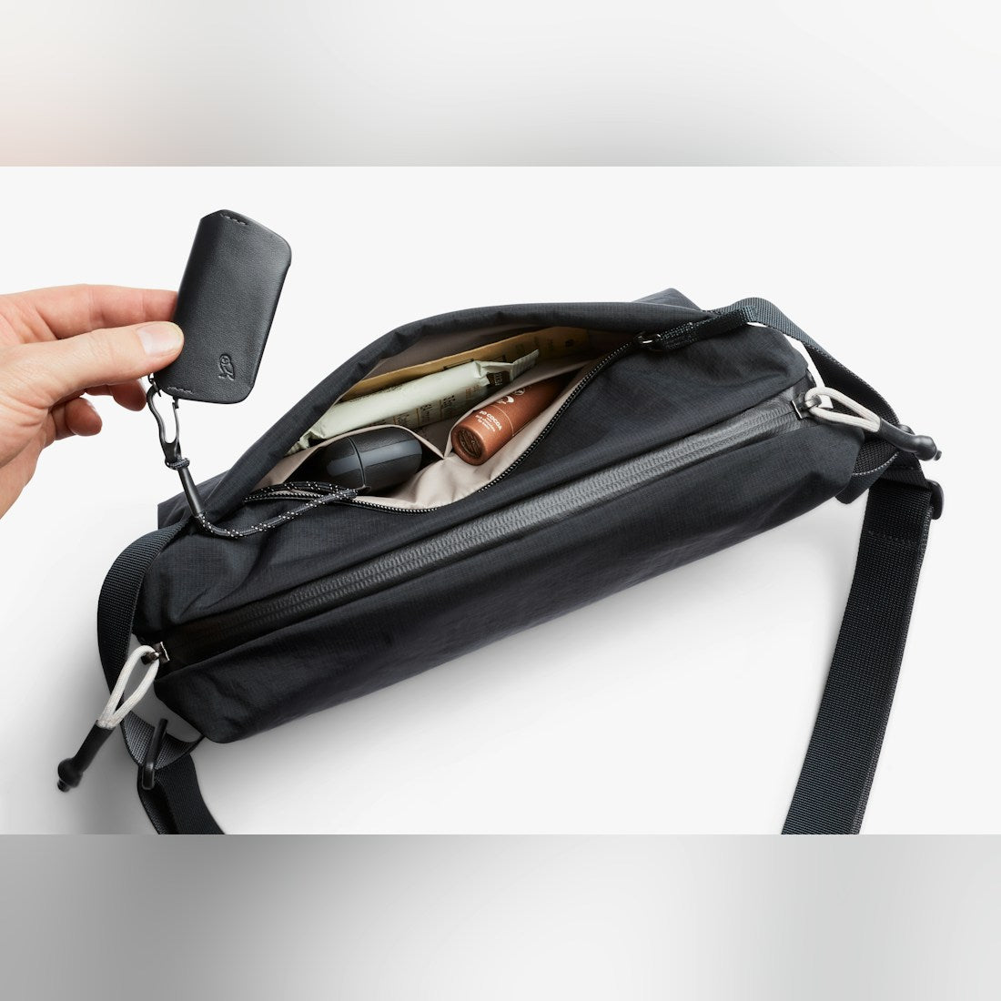 Bellroy Lite Sling in Black, open top view with contents - The Simple Man