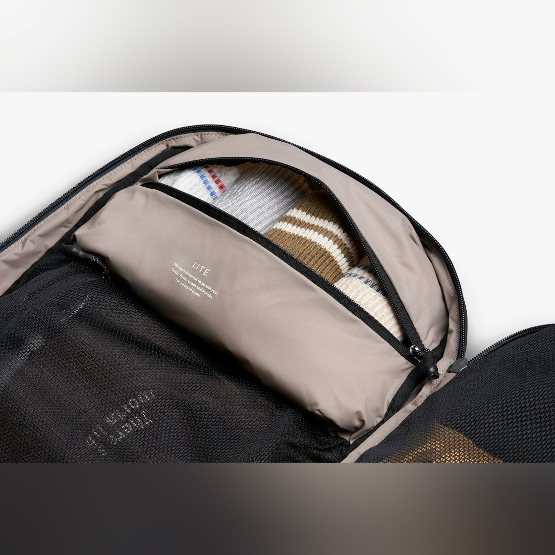 Bellroy Lite Travel Pack 38L carry-on backpack in Black, inside view with packed gear - The Simple Man