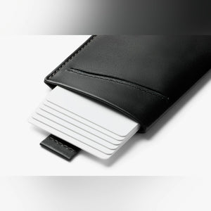 Bellroy Card Sleeve wallet in Black, stack of cards sliding out of the front slot - The Simple Man