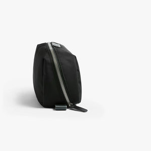 Bellroy Toiletry Kit Plus travel toiletry bag in Black, standing upright, side view with zip - The Simple Man