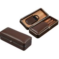 Brown leather cigar case with open lid showing accessories on a white background